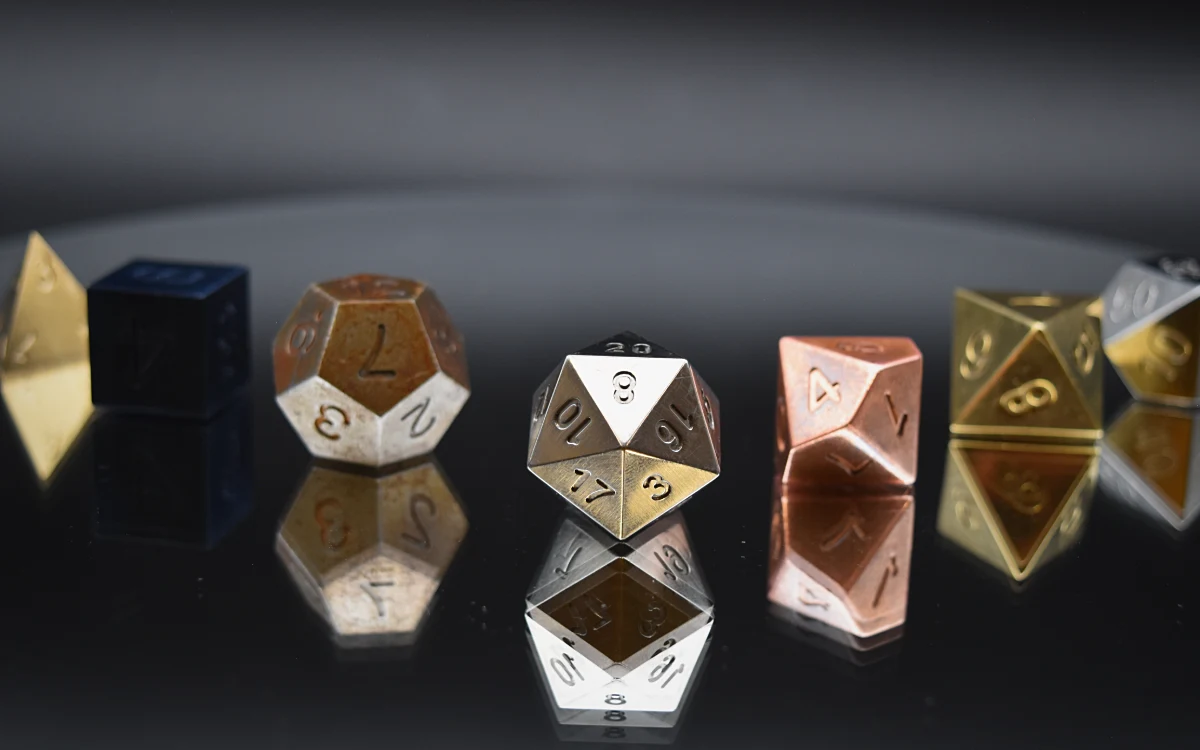 The seven Martials dice on a dark reflective surface.