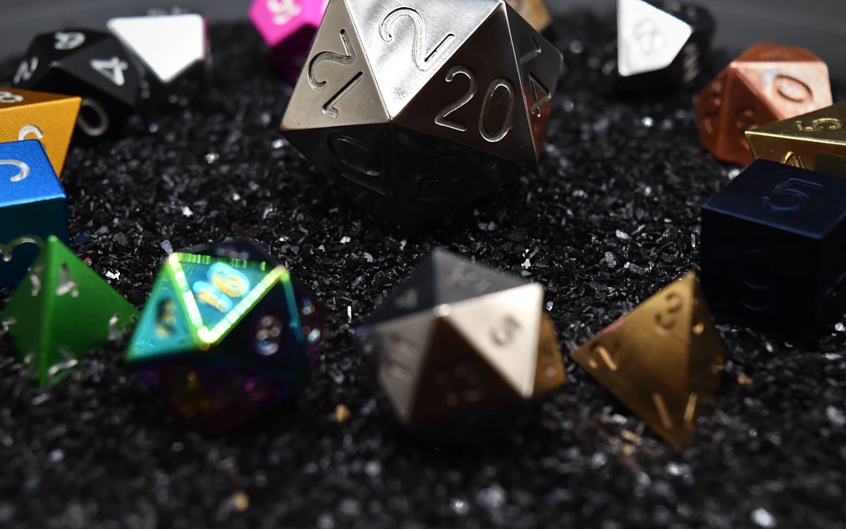 All fifteen dice of the Pantheon on black grit.