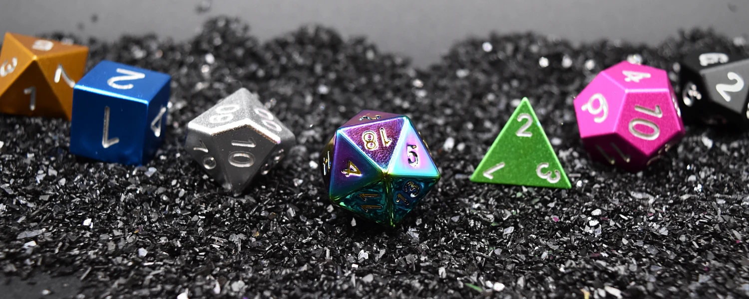 The seven Casters dice laid out on black grit.